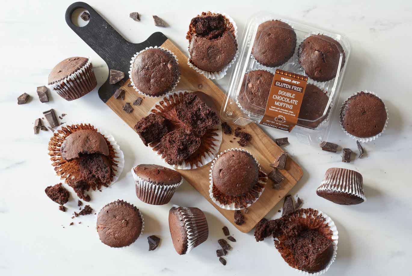 Trader Joe's Gluten Free Double Chocolate Muffins; on marble surface and wood board, some muffins broken up