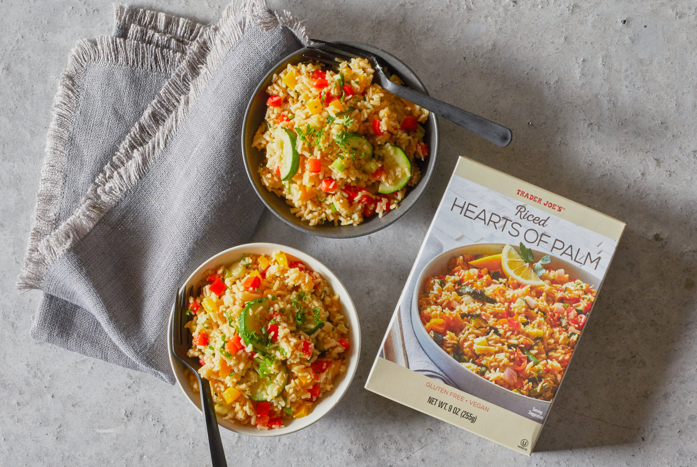 Trader Joe's Riced Hearts of Palm; prepared with zucchini, red and yellow bell pepper and onion. In two bowls with forks