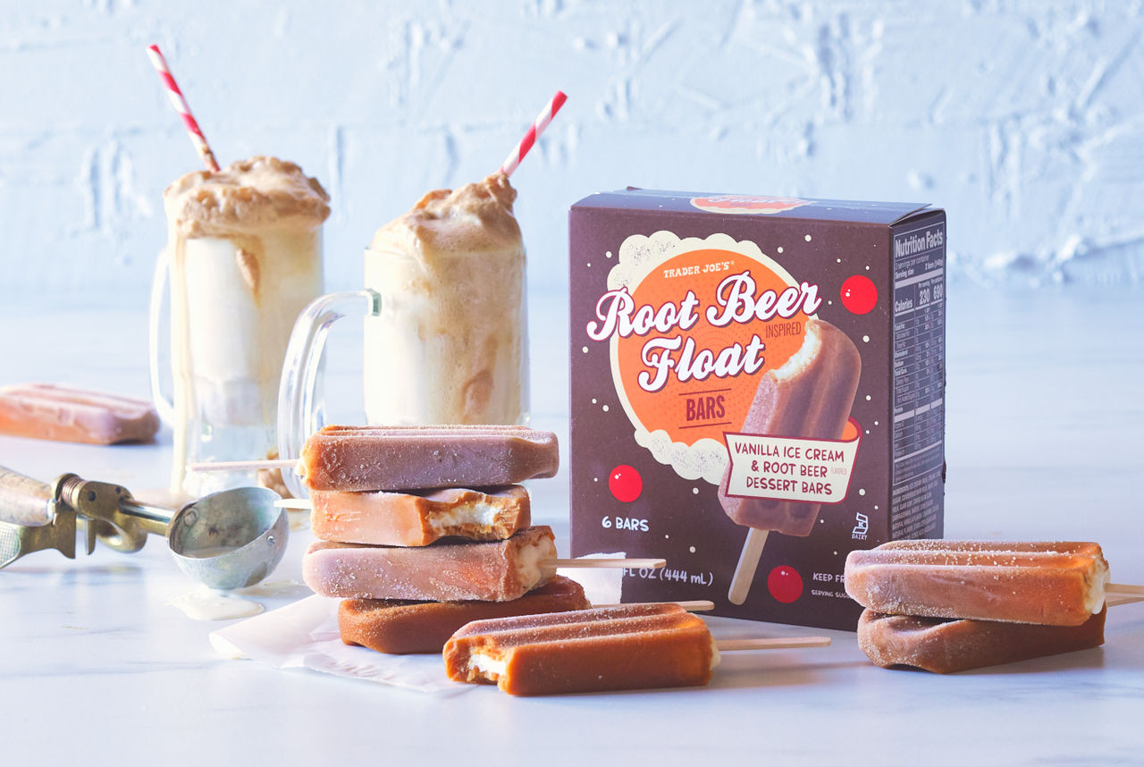 Trader Joe's Root Beer Float Bars; bars stacked on white surface, two root beer floats in background with ice cream scoop