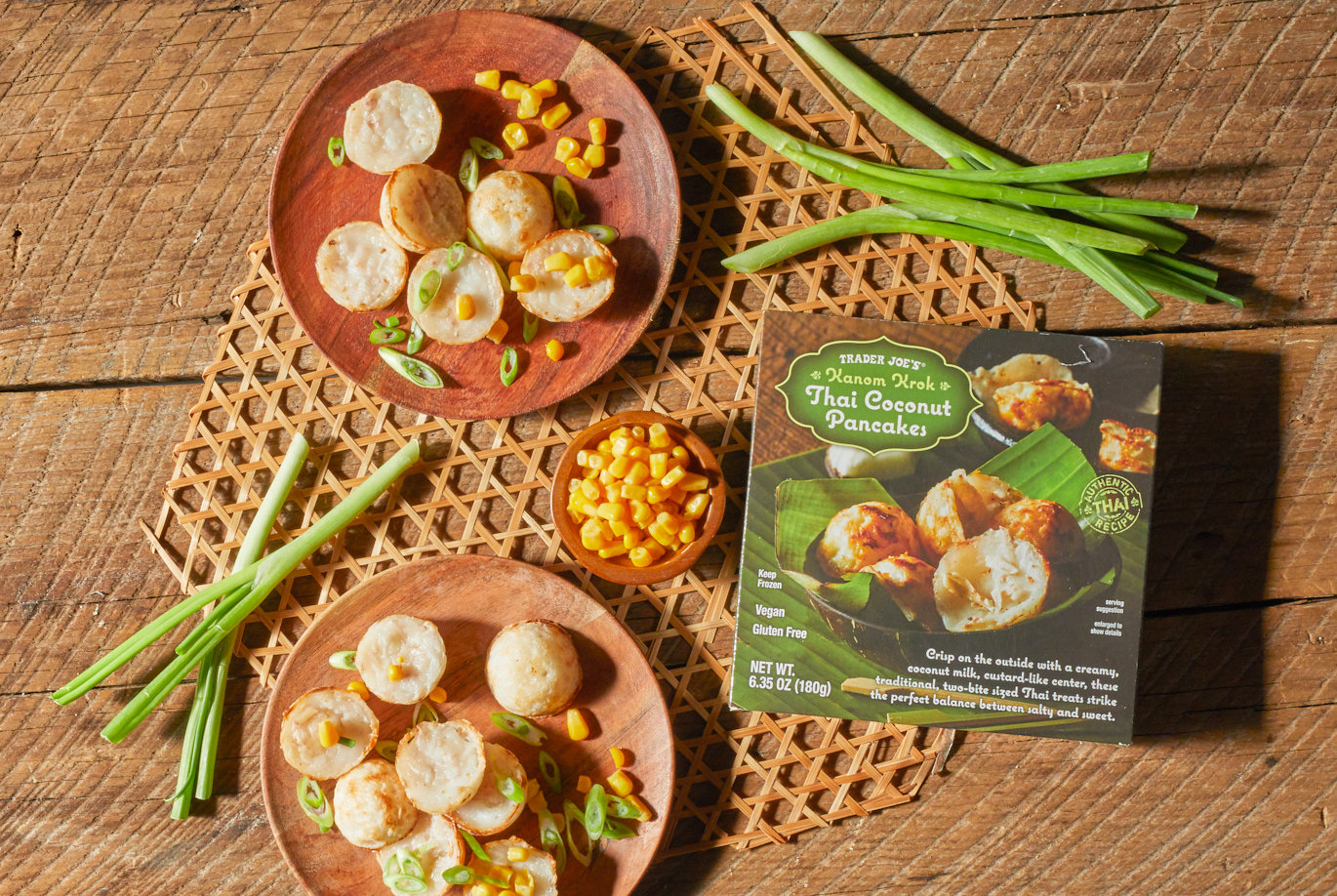 Trader Joe's Thai Coconut Pancakes; shown on wood plates, topped with corn kernels and sliced green onions